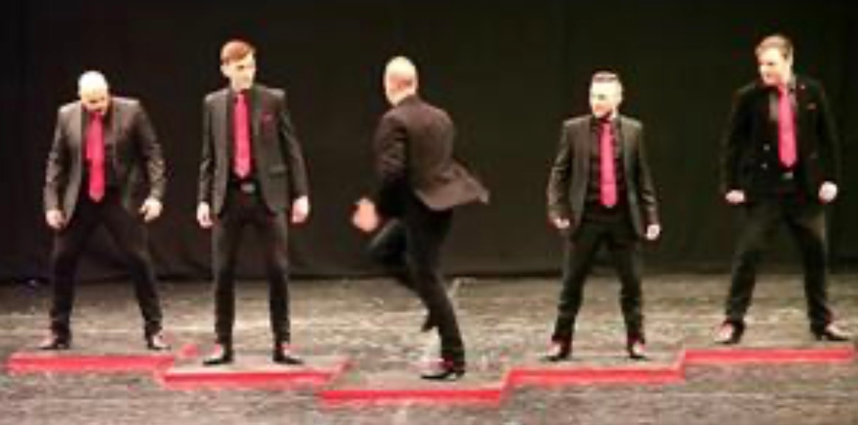 Five dancers walk onto the stage, but the man standing in the middle suddenly turns around and instantly becomes the center of attention…